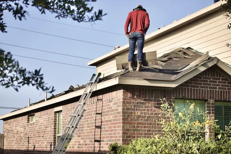 Professional roofer working on a residential roof in Fort Wayne